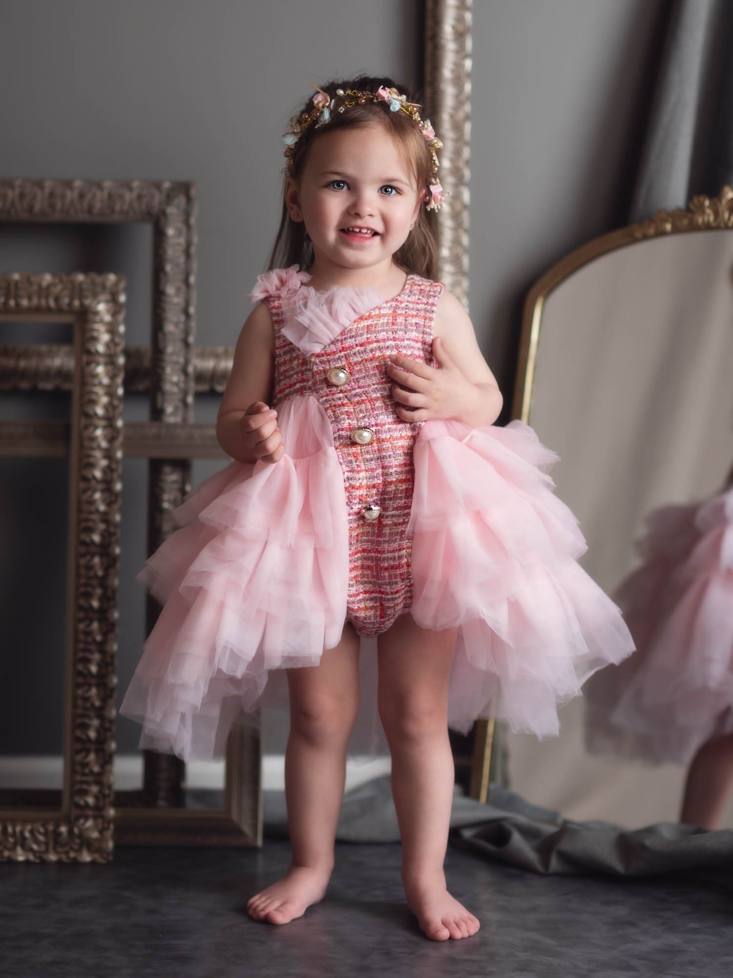 Toddler girl wearing Kellie Pink Tweed Romper with layered pink tulle skirt and pearl buttons, styled as a luxury birthday and special occasion outfit