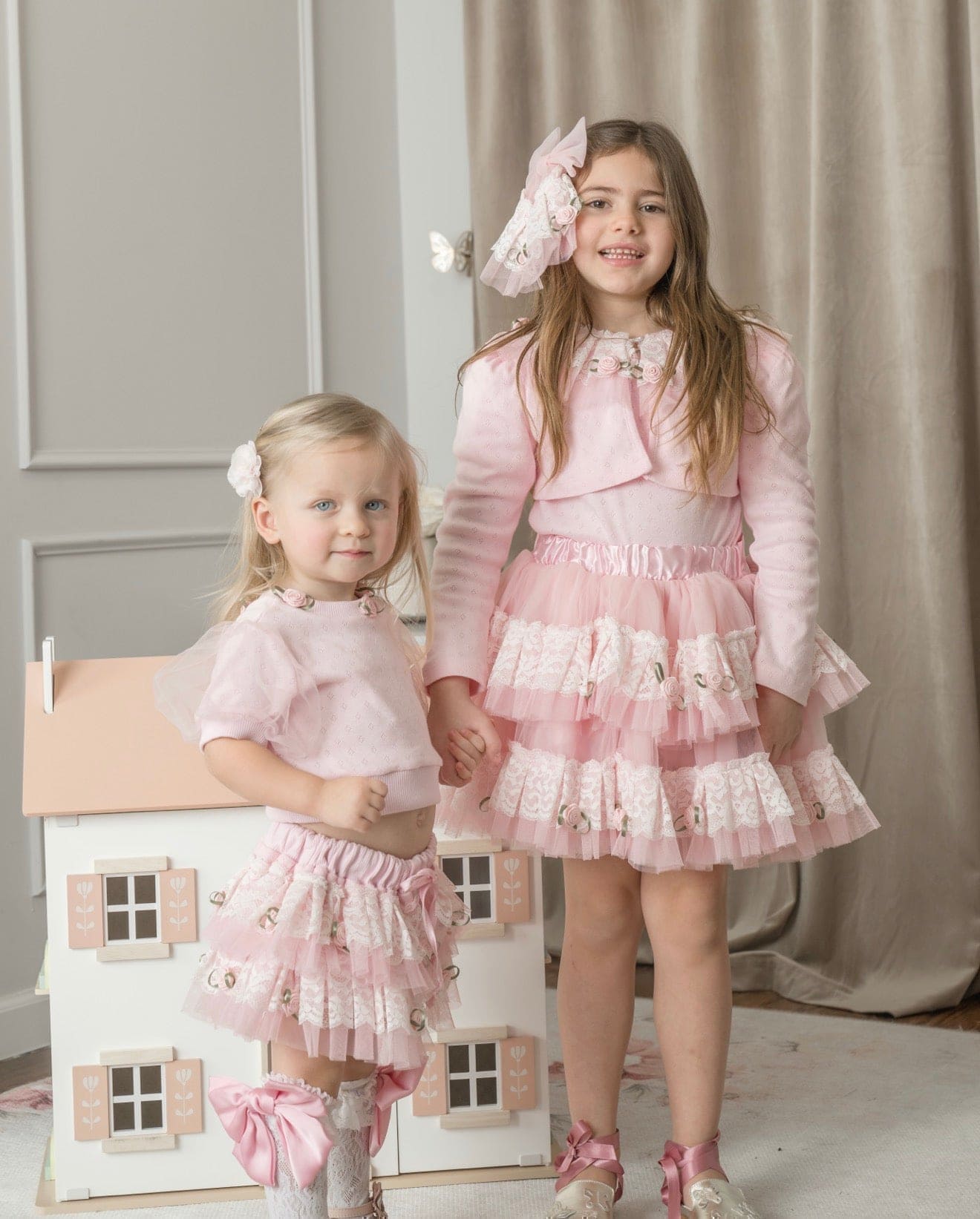 Girls wearing pink embroidered top with lace details