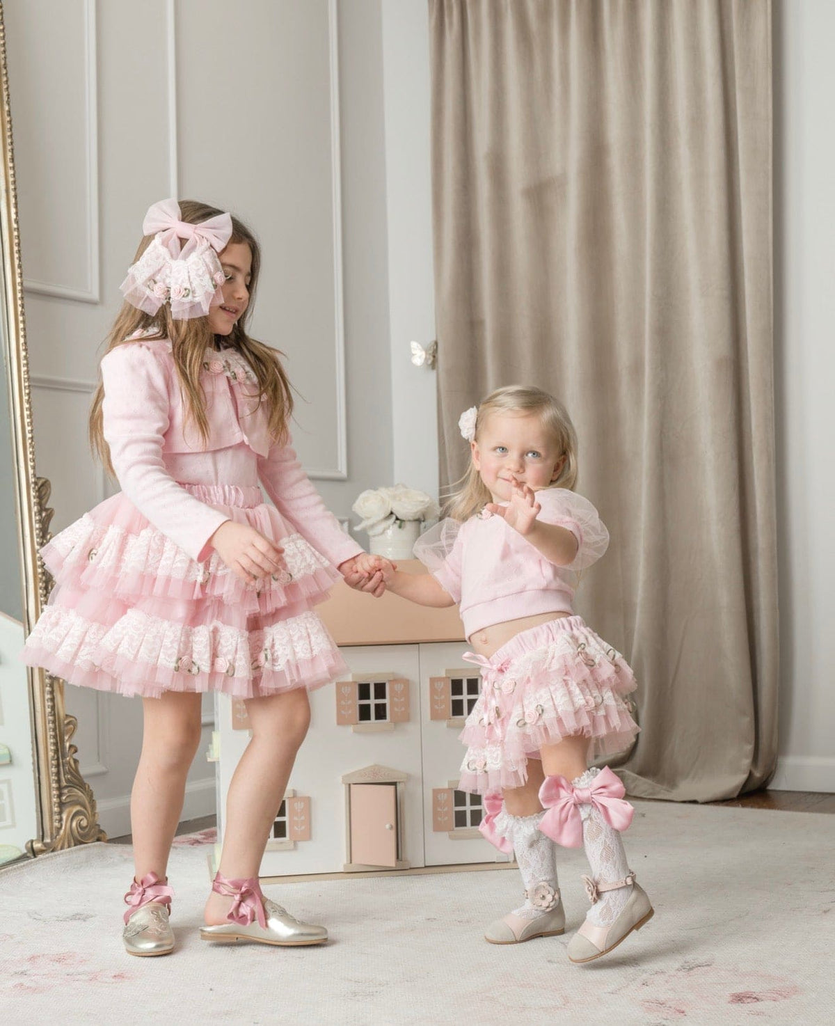 Girls wearing pink embroidered top with lace details