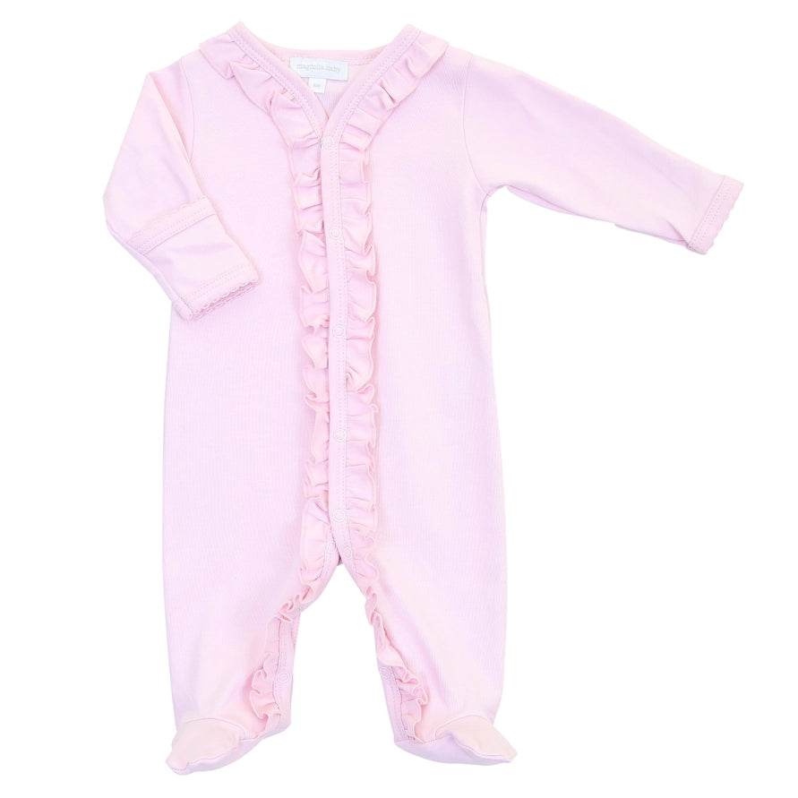 A light pink baby footed sleeper with long sleeves, ruffled trim along the front placket, and ruffled cuffs and ankles, shown on a plain white background.