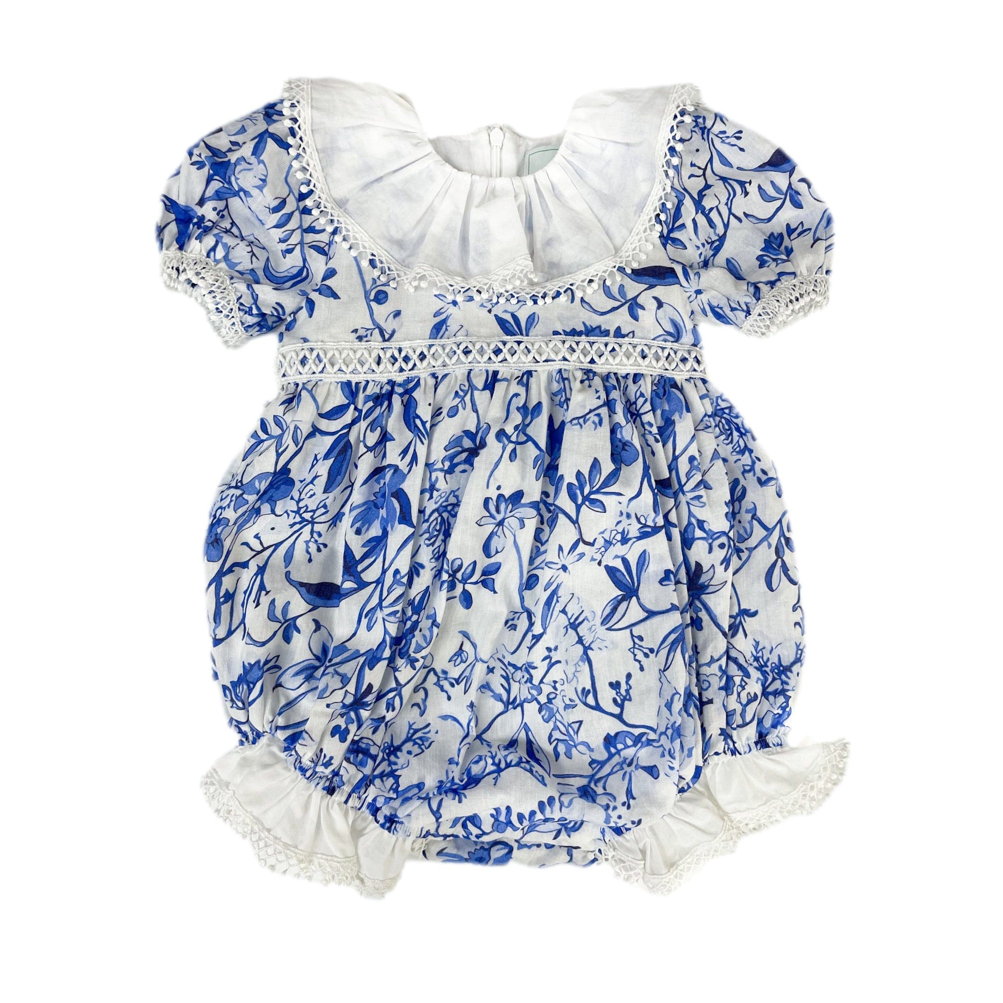 Blue and white floral romper with lace detail and back bow. Soft cotton lining and snap closure for easy diaper changes. Perfect for special moments.