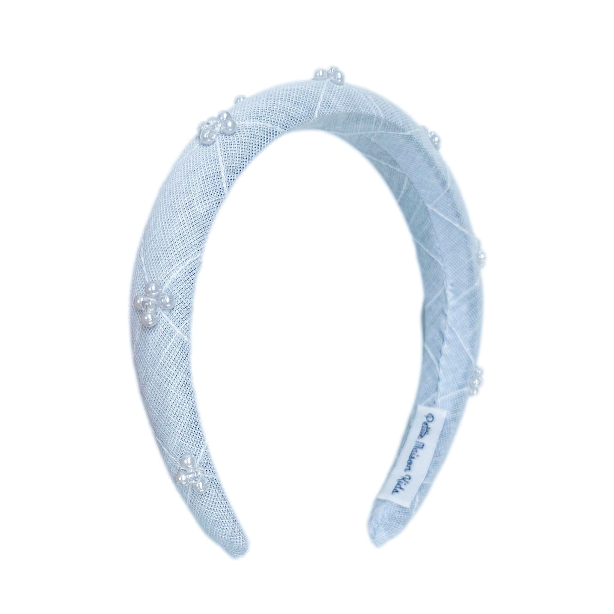 Baby blue linen headband with faux pearl geometric detail. Elegant accessory designed to match the Charlotte Collection.
