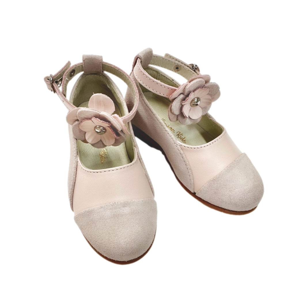 Faina pink leather Mary janes for girls with floral ankle strap detail, soft suede toe cap and classic round toe silhouette on white background