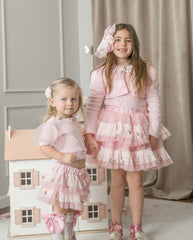 Girls wearing pink embroidered top with lace details 