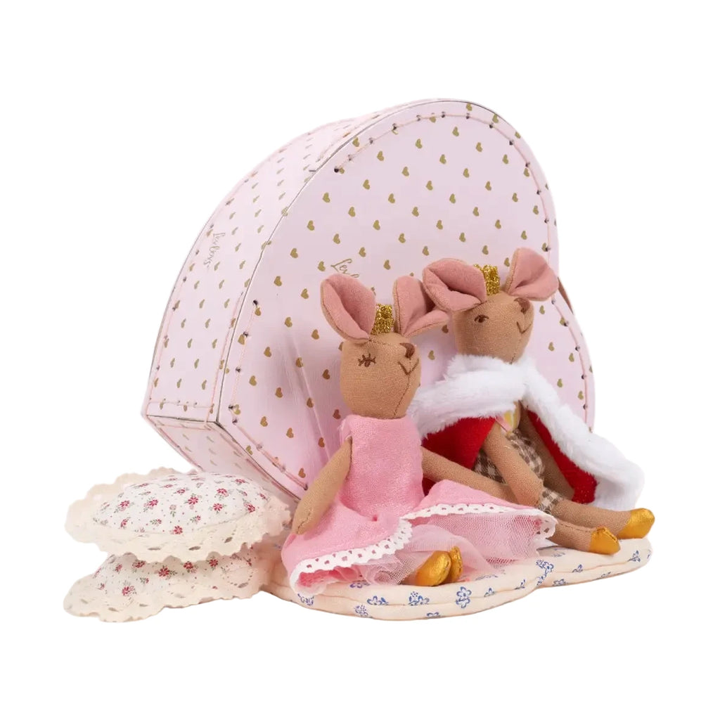 Two plush toys in dresses with a pink polka dot box on a white background