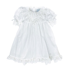 Katherine white linen girls dress with embroidered lace detail, large back tie bow, below the knee silhouette, and lightweight fabric.