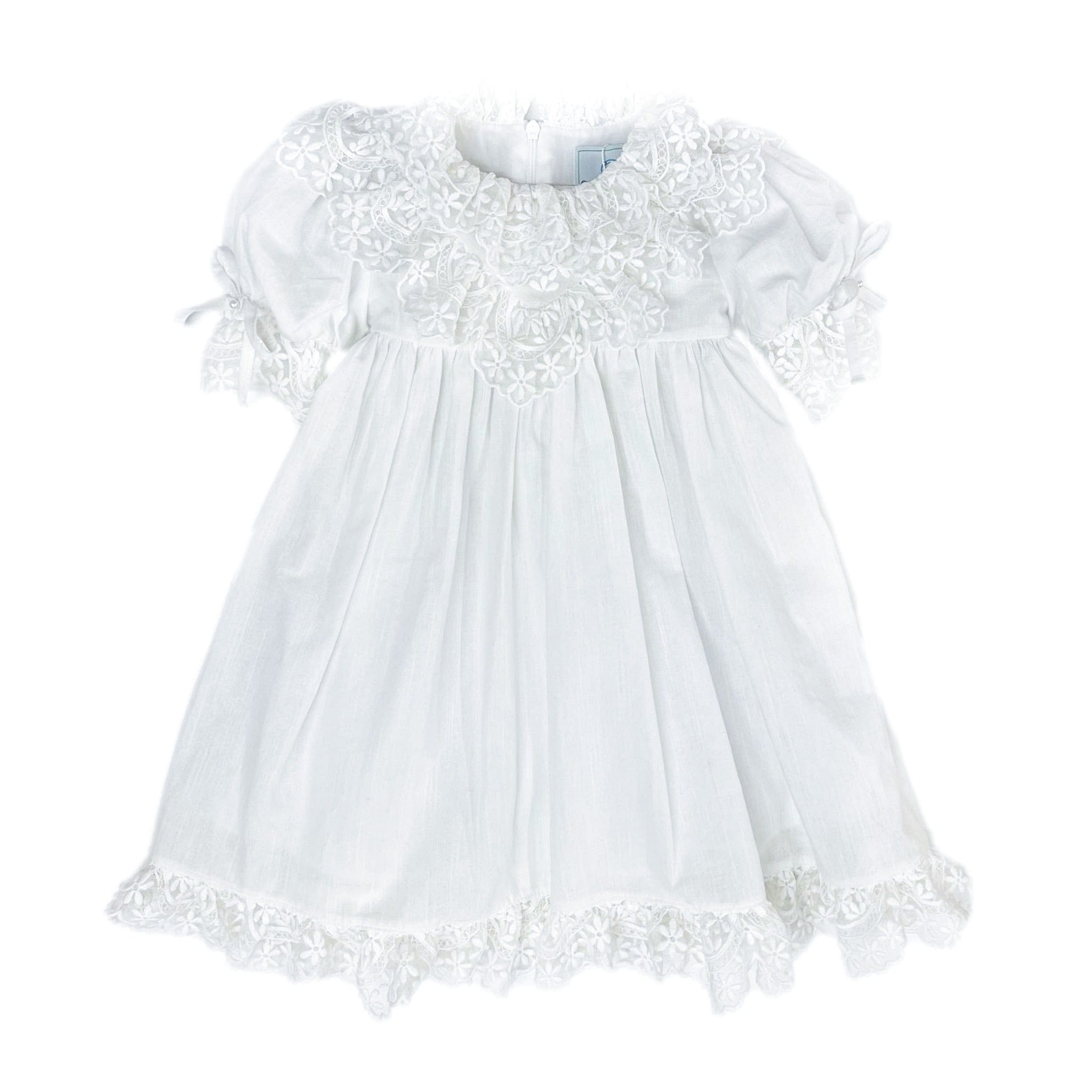Katherine white linen girls dress with embroidered lace detail, large back tie bow, below the knee silhouette, and lightweight fabric.