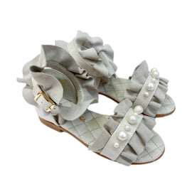 Suede and patent leather open toe girls sandals with faux pearls, suede ruffle trim, gold buckle, cushioned insole, and anti slip sole.